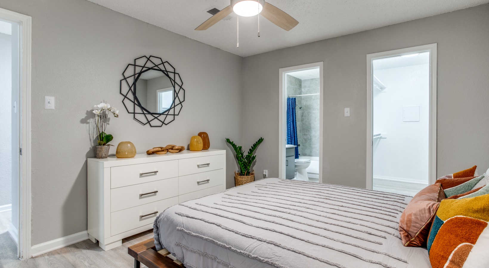 a bedroom with a white bed and a ceiling fan at The  Booker