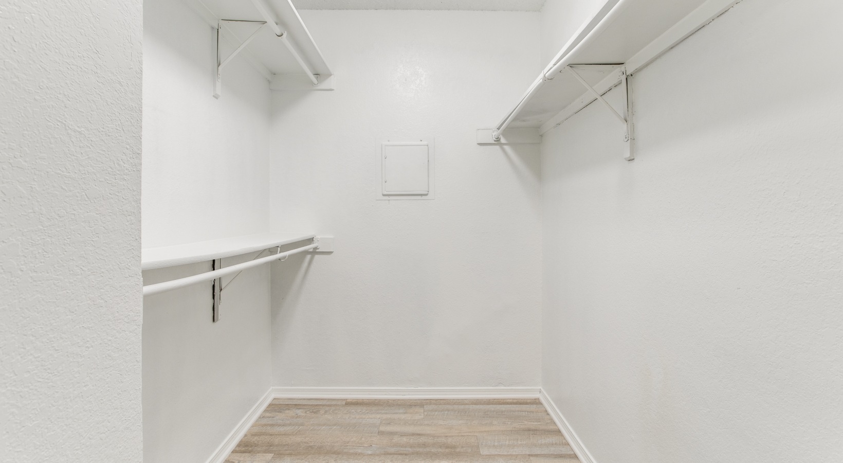 a white closet with shelves and white walls at The  Booker