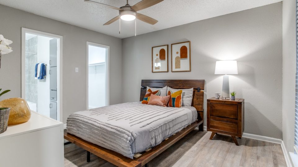 a bedroom with a bed, a ceiling fan and a light fixture at The  Booker