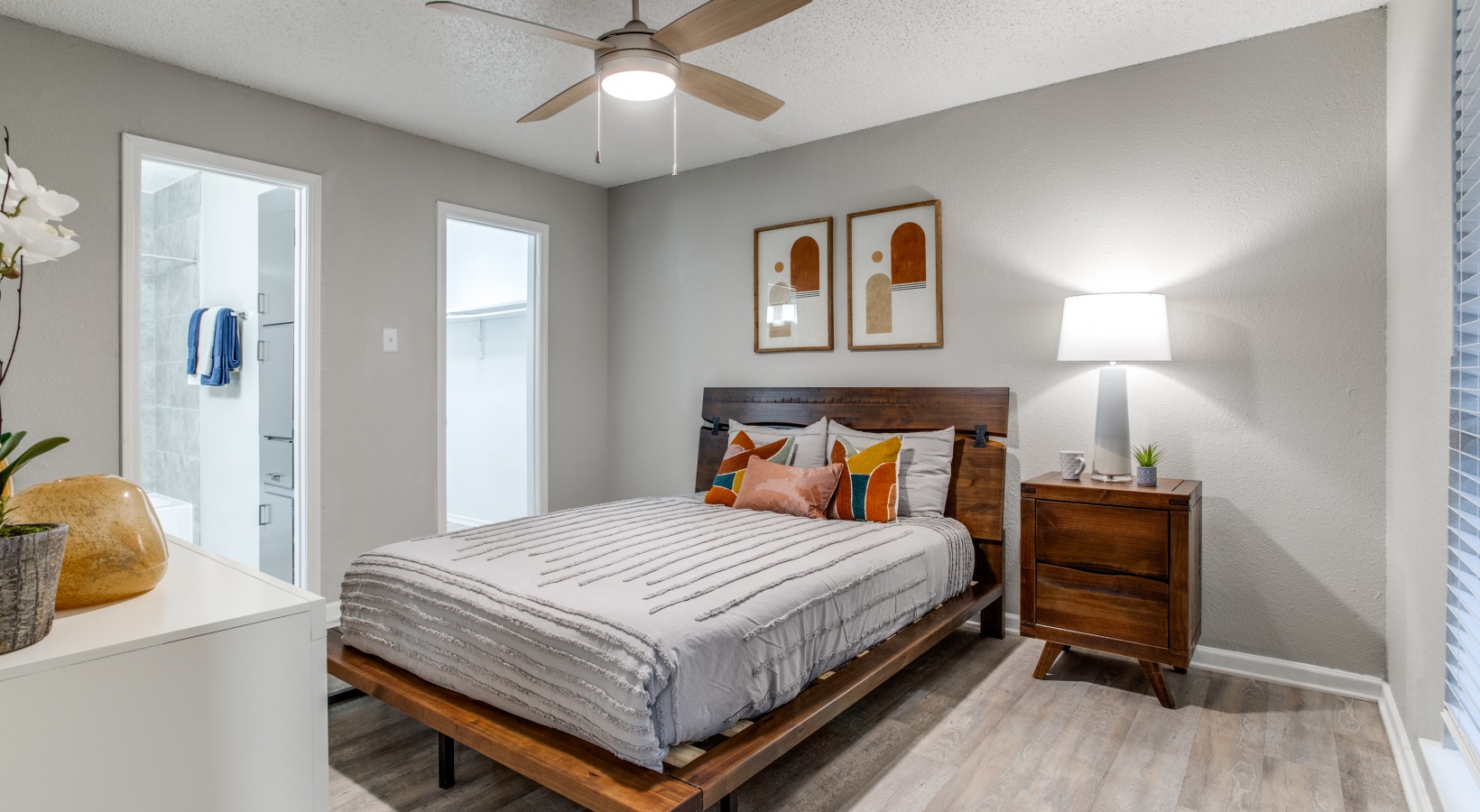 a bedroom with a bed, a ceiling fan and a light fixture at The Booker